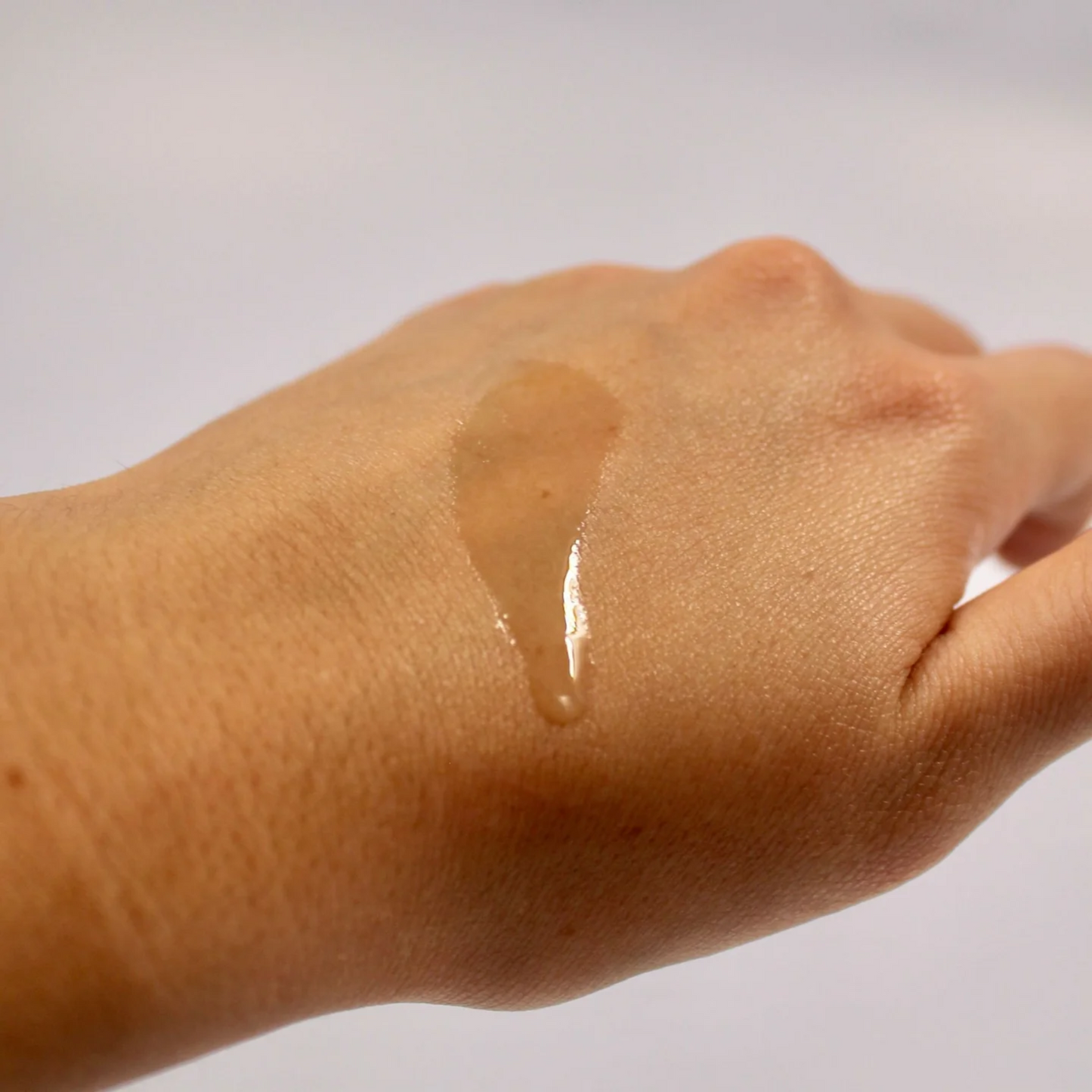 retrato de una gota del limpiador facial suave sobre mano blauverde disponible en blumma